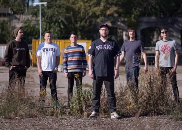 Smoove and Turrell standing in a car park