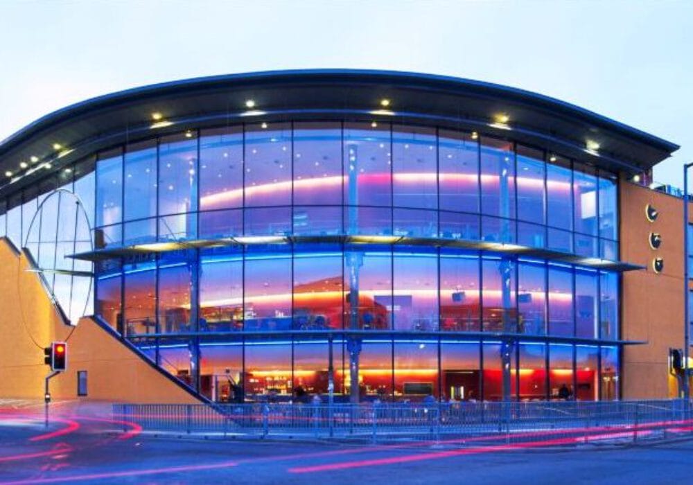 ARC in Stockton, a glass fronted building lit purple from inside