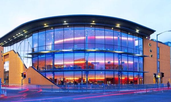 ARC in Stockton, a glass fronted building lit purple from inside