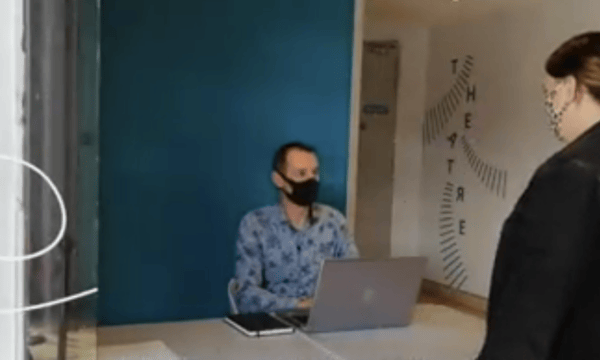 Man with mask at desk