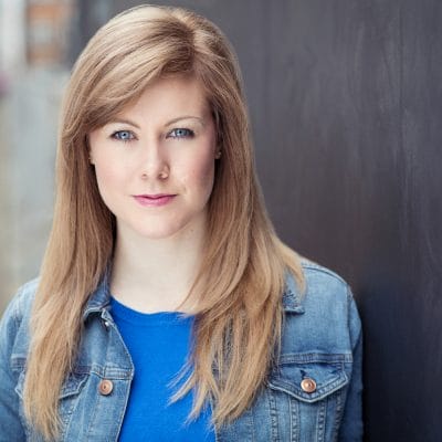 Headshot of Maria Crocker, a woman with long, straight blonde hait wearing a blue top and a blue denim jacket.