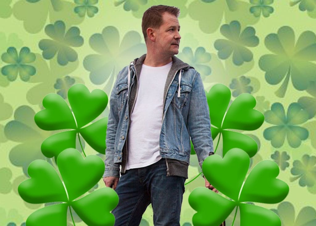 Mike Mcgrother standing in among shamrocks