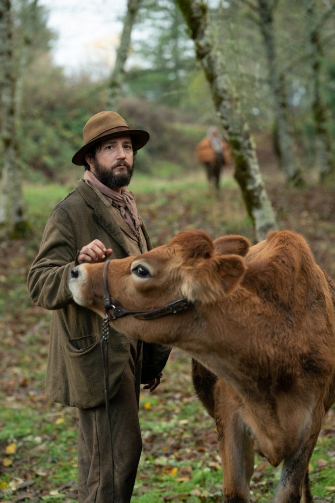 Man in a cowboy hat with a cow