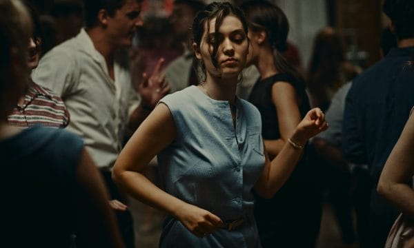 A woman dances in the middle of a crowd of other people