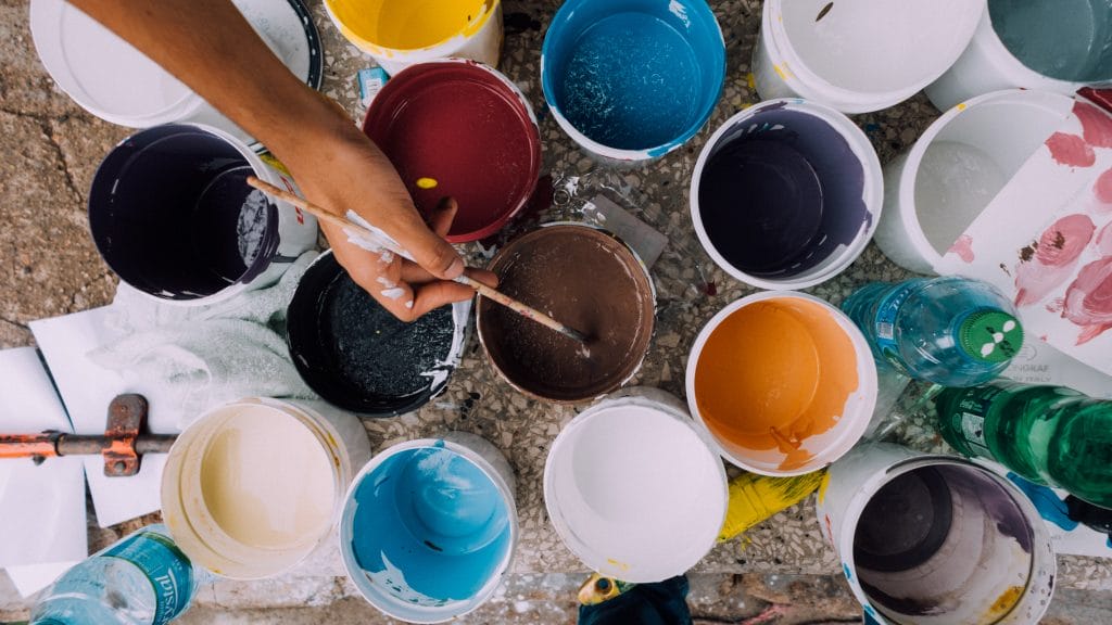 An aerial shot of a collection of paint pots in varying colours.