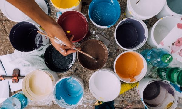 An aerial shot of a collection of paint pots in varying colours.