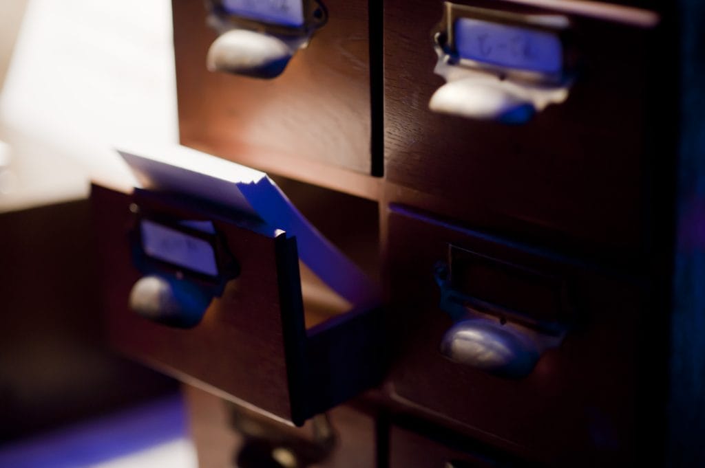 Index cards in a small wooden drawer