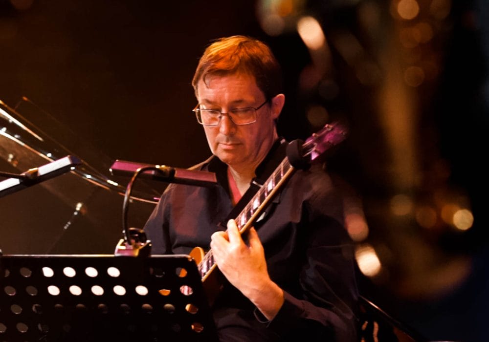 A musician looking intently at his sheet music.