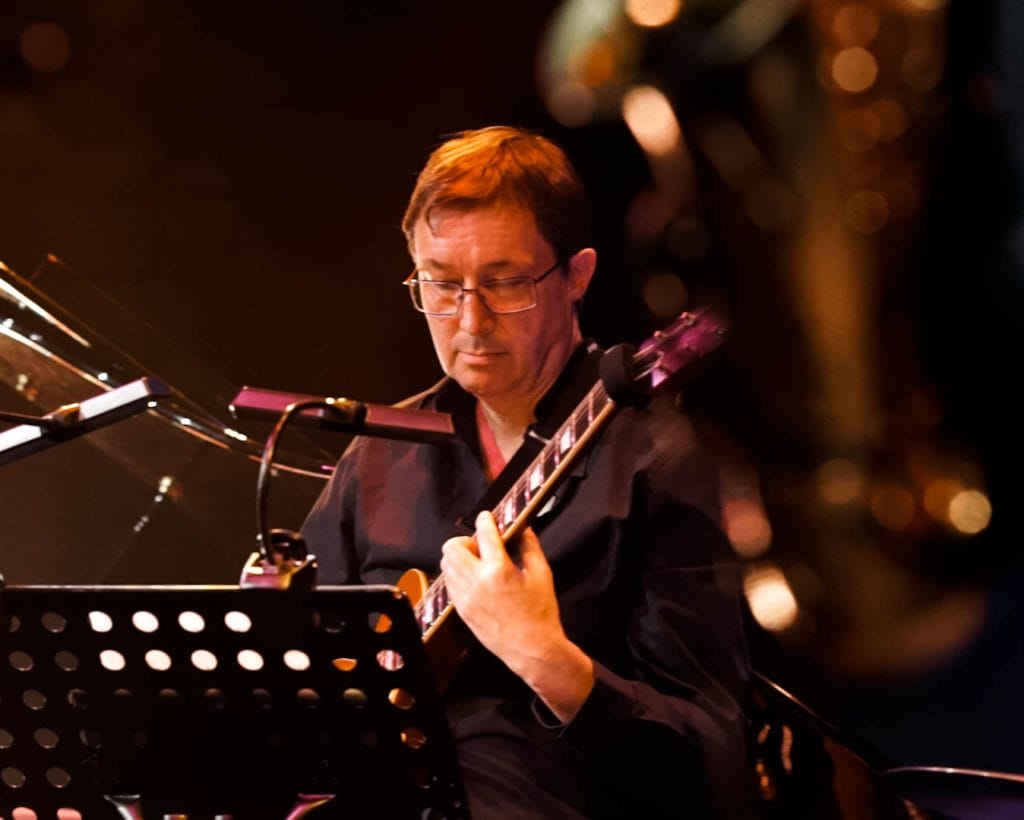 A musician looking intently at his sheet music.