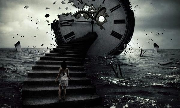 A person walks up stone steps rising out of the sea, towards a large smashed clock at the top