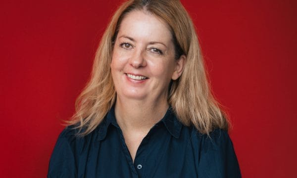 ARC's new Family Arts Coordinator Judith Crompton. Judith is a white woman with shoulder length blonde hair. She is wearing a long sleeved black blouse and smiling towards the camera.