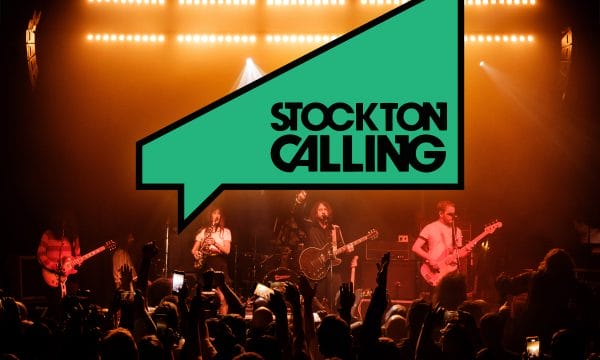 Stockton Calling's logo sits above a 4 piece band playing to a crowd of people