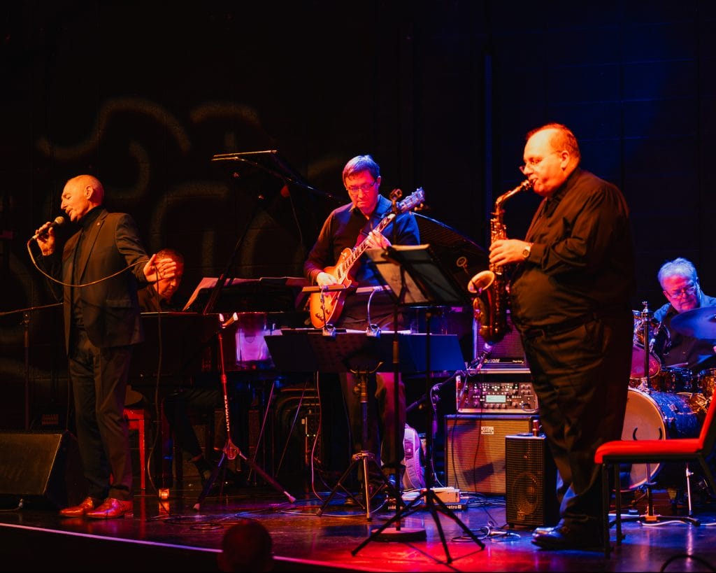 Drummer Paul, Sax player Mark, guitar player Paul, Tony Maxwell on vocals and Jeremy on piano all perform on stage