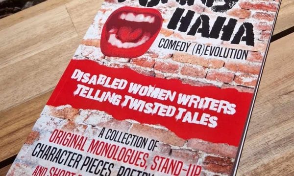 Funny Haha Book Displayed on a table, book cover contents: The background is an aged brick wall. There is a cutout of a wide open mouth with bright red lips. The title in bold black caps reads Funny Haha, with a subheading Comedy (R)evolution. A red strip with white text reads Disabled Women Writers Telling Twisted Tales. Text below reads A collection of orginal monologues, stand-up, character pieces, poetry, sketches and short plays for performance.