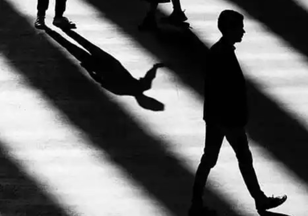 Silhouetted figures and their shadows