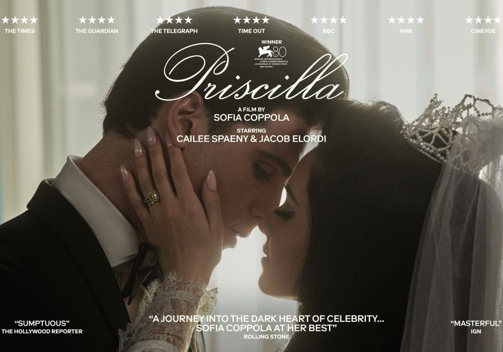 Elvis and Priscilla embrace and look lovingly at each other