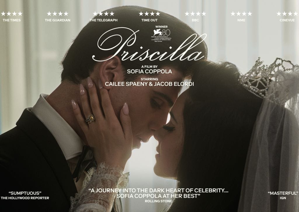 Elvis and Priscilla embrace and look lovingly at each other