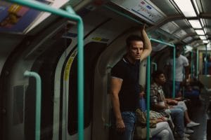 Andrew Scott on a train looking hazed.