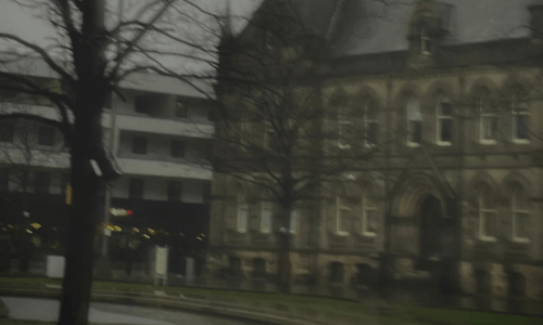 Blurred, gloomy looking shot of Middlesbrough Town Hall and Centre Square, with the Holiday Inn in the background