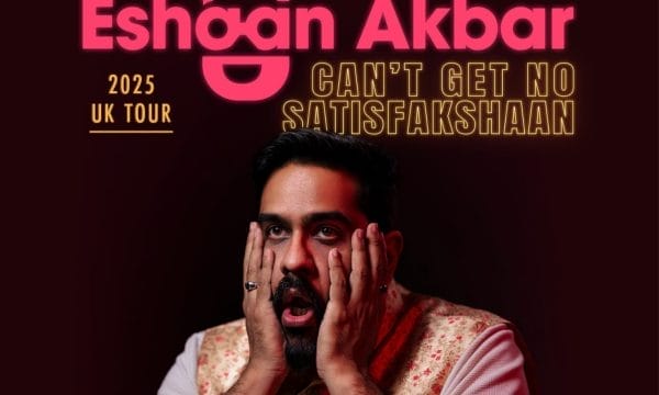 Comedian Eshaan Akbar, a brown-skinned man with short black hair and a small beard, has his head in his hands. Text reads Eshaan Akbar Can't Get No Satisfakshaan