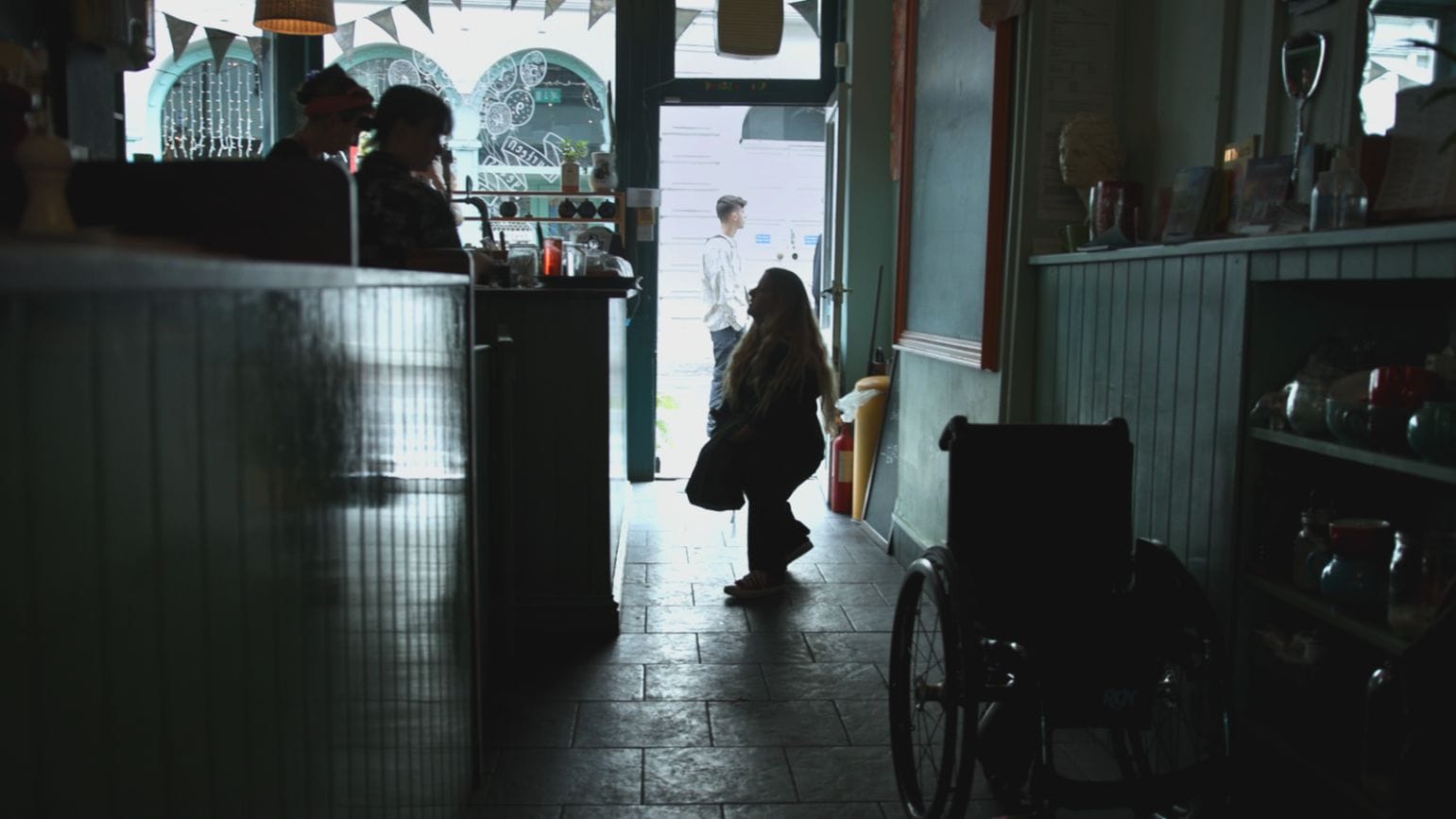 Ella ordering in a cafe captured in a silhouette.