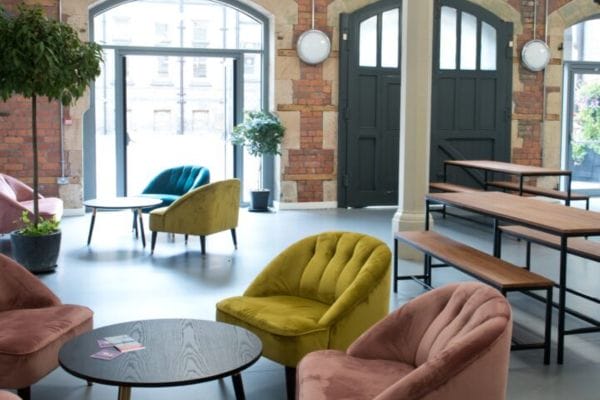 Interior of the Old Fire Station space at Middlesbrough Town Hall, with a mix of styles of casual seating and tables/benches.