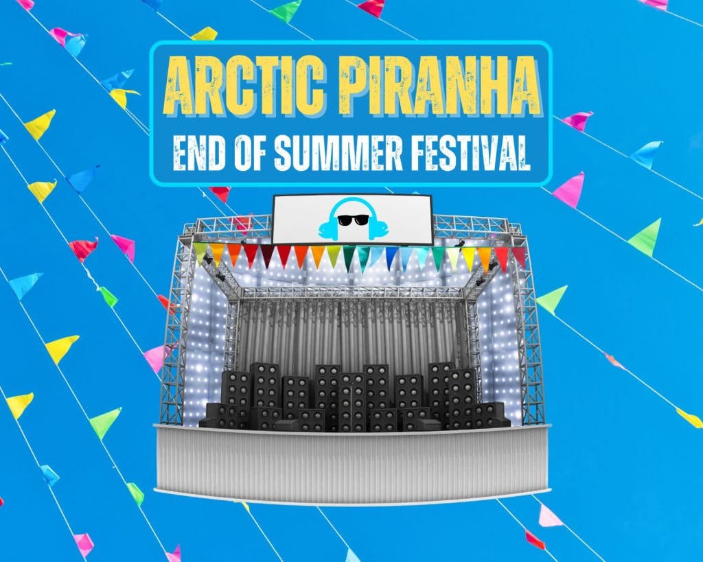 Promotional poster for 'Arctic Piranha End of Summer Festival'. The background is bright blue with colorful triangular flags. In the center is an illustration of a concert stage with speakers, lights, and a large screen showing a stylized DJ icon wearing sunglasses and headphones. The stage is decorated with multicolored pennant flags. The festival name is displayed in large text at the top, with 'Arctic Piranha' in yellow and 'End of Summer Festival' in white