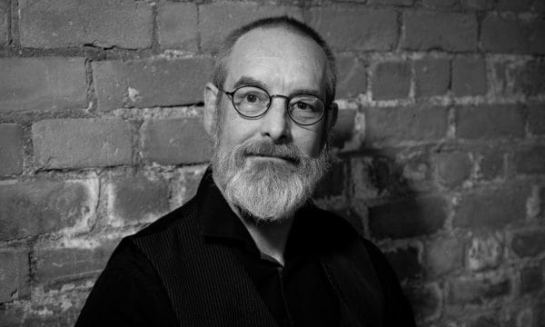 A black and white headshot of Dr Bob Beagrie, a white man, with shortly cropped hair and a grey beard.