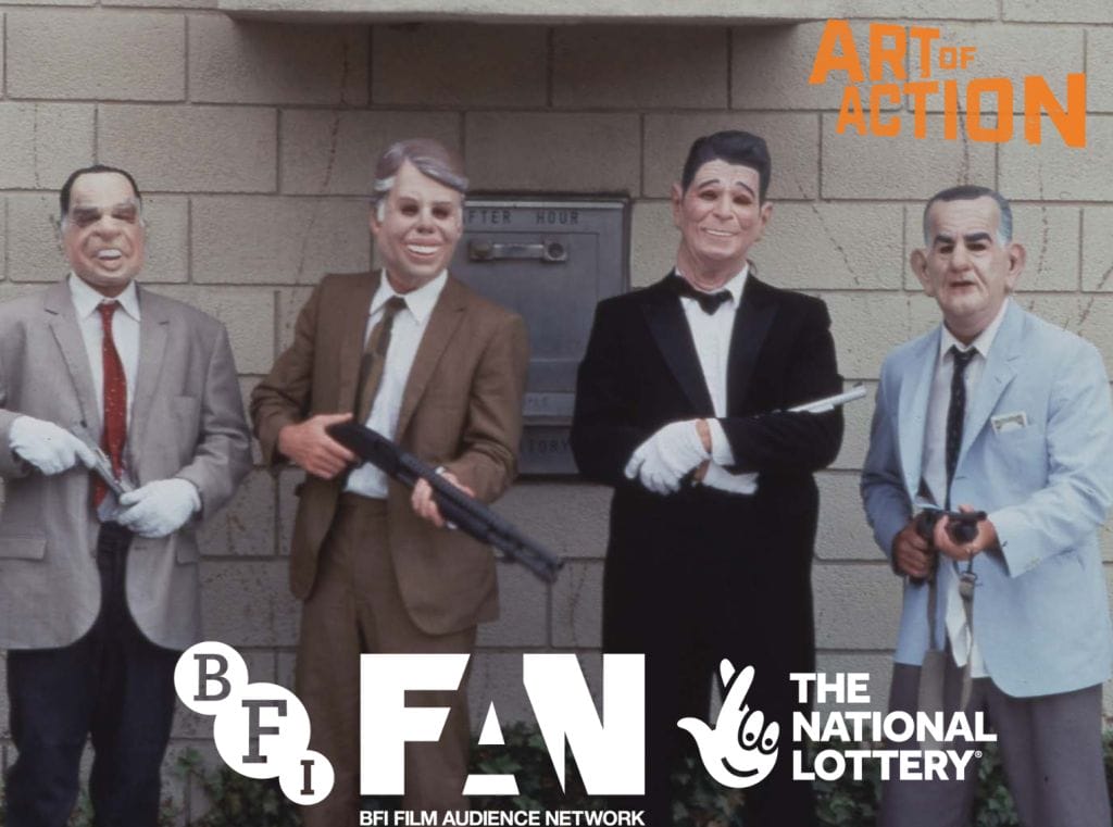 The image shows four men stood in front of a wall. They all of masks on and are wearing suits with shirts and ties each holding guns. To the top right is an orange Art of Action logo. The bottom centre has a white BFI, FAN, and The National Lottery logo.