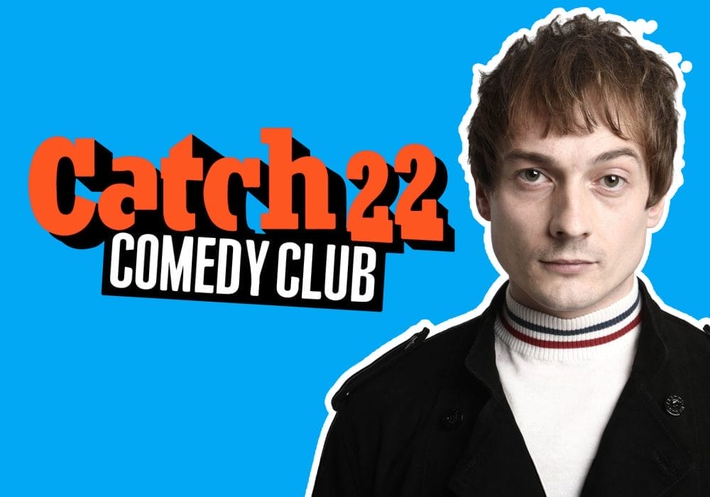 Comedian Matt Bragg, a young white man with short brown hair, stands alongside an orange Catch 22 Comedy Club logo.