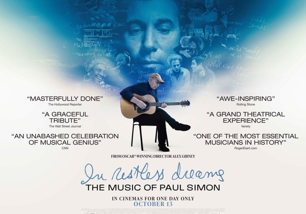 In Restless Dreams Paul Simon Sat crossed legged on a chair playing a guitar