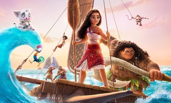 Animated characters from Disney's Moana stand on a wooden raft on a choppy ocean. Moana is at the helm of the raft holding a wooden oar. To her right is Maui holding a large fish hook. To the left of Moana is her pet pig Pua sitting on top of a wave.