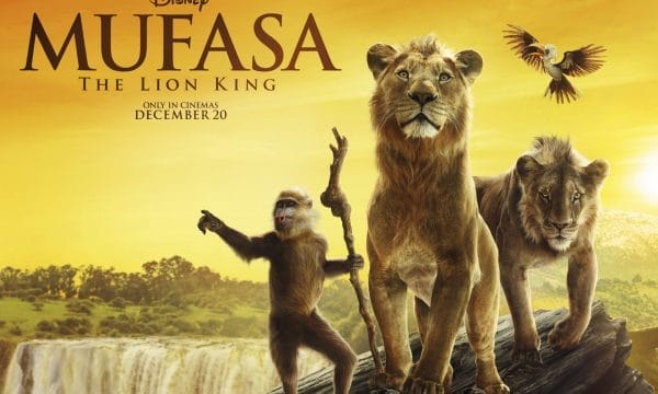 Two lions, and a baboon holding a wooden staff, stand on the edge of a sharp cliff. Text reads: experience the story of the one true king, Mufasa The Lion King