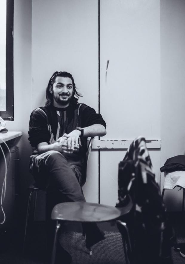 Actor Arun Graves-Kochhar, Northern School of Art, sitting in a chair in a rehearsal room