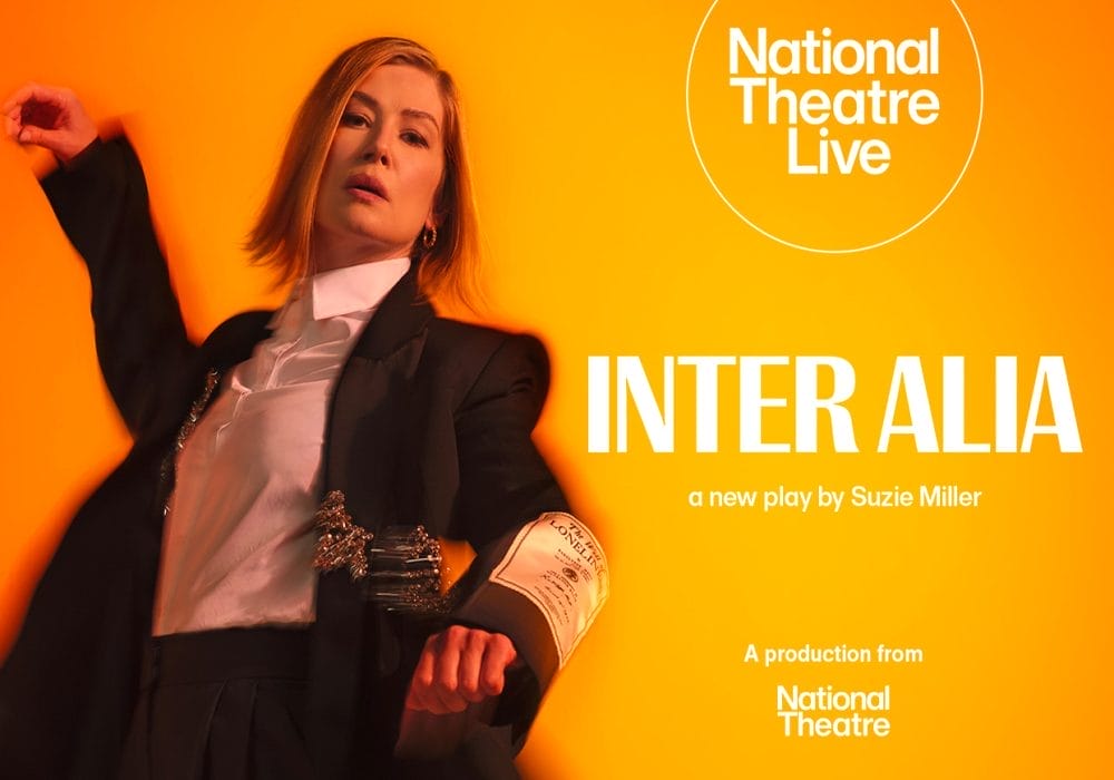 a person in a black suit with a white shirt against a vibrant orange/yellow background. The National Theatre and National Theatre Live logos appear on the left side of the image.