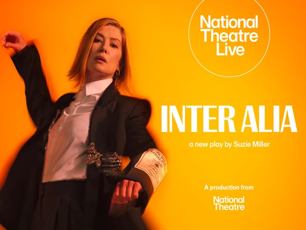 a person in a black suit with a white shirt against a vibrant orange/yellow background. The National Theatre and National Theatre Live logos appear on the left side of the image.
