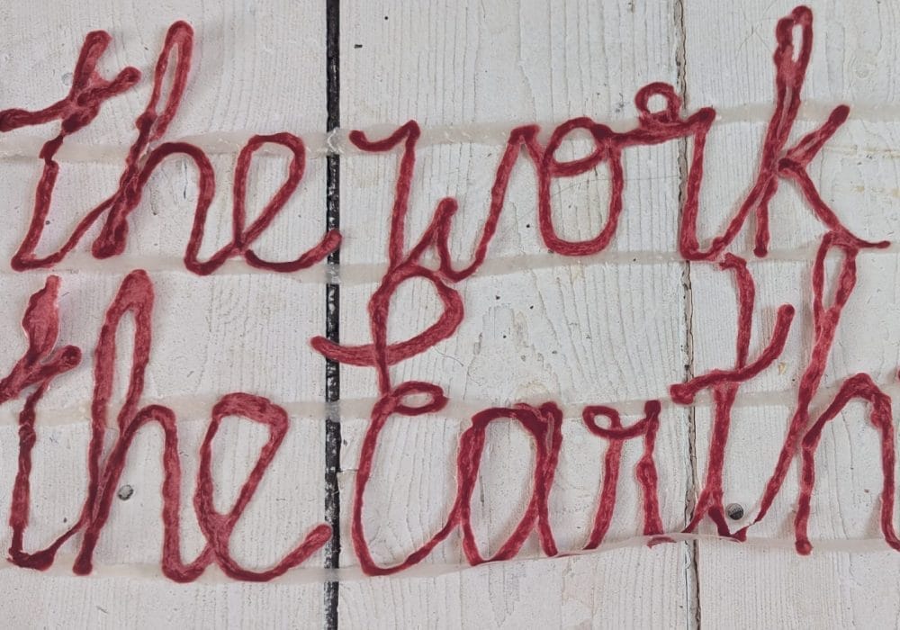 an image of red string that says 'the work the earth'