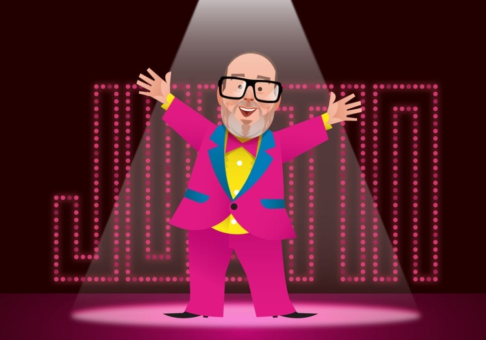 A 2D cartoon of a bald man wearing glasses in a pink suit with his arms outstretched. there is a spotlight on him and in the background show lights spell out the word 'Justin'