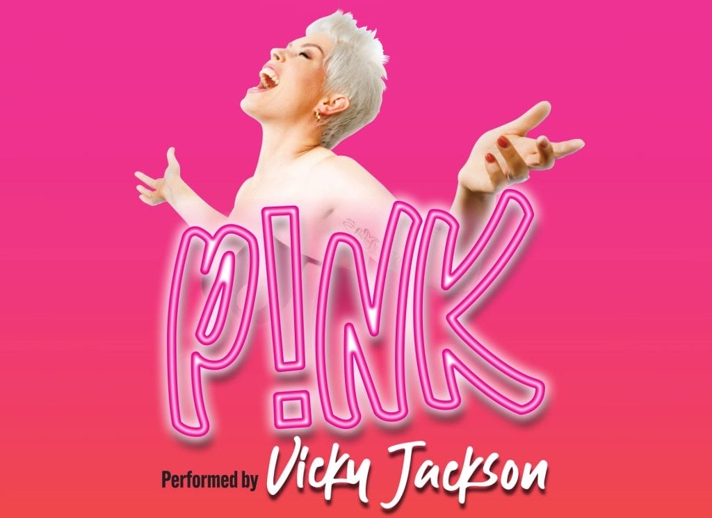 a promotional poster for a tribute show to the artist Pink. The poster features: A bright pink background The text "THE WORLD'S NO.1 TRIBUTE TO" at the top A large neon-style "P!NK" logo in the centre "Performed by Vicky Jackson" at the bottom The image shows a performer with short blonde/white hair in a pose reminiscent of Pink's energetic performance style, with arms outstretched against the vibrant pink backdrop.