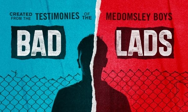 An image split in half like ripped paper, the left side is in a block blue colour and the left in red, in the centre there is a silhouette of a boy. Across the back there is a chain link fence. Above the writing reads 'Bad Lads'.