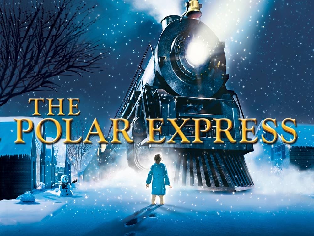 An image of a boy looking up at a large train, the background is covered with snow. In the middle in gold writing it reads 'The Polar Express'.