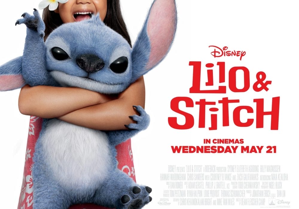 the beloved blue alien character Stitch being hugged by a young girl (Lilo) who has a plumeria flower in her hair. The poster indicates the film was released in cinemas on Wednesday, May 21st.