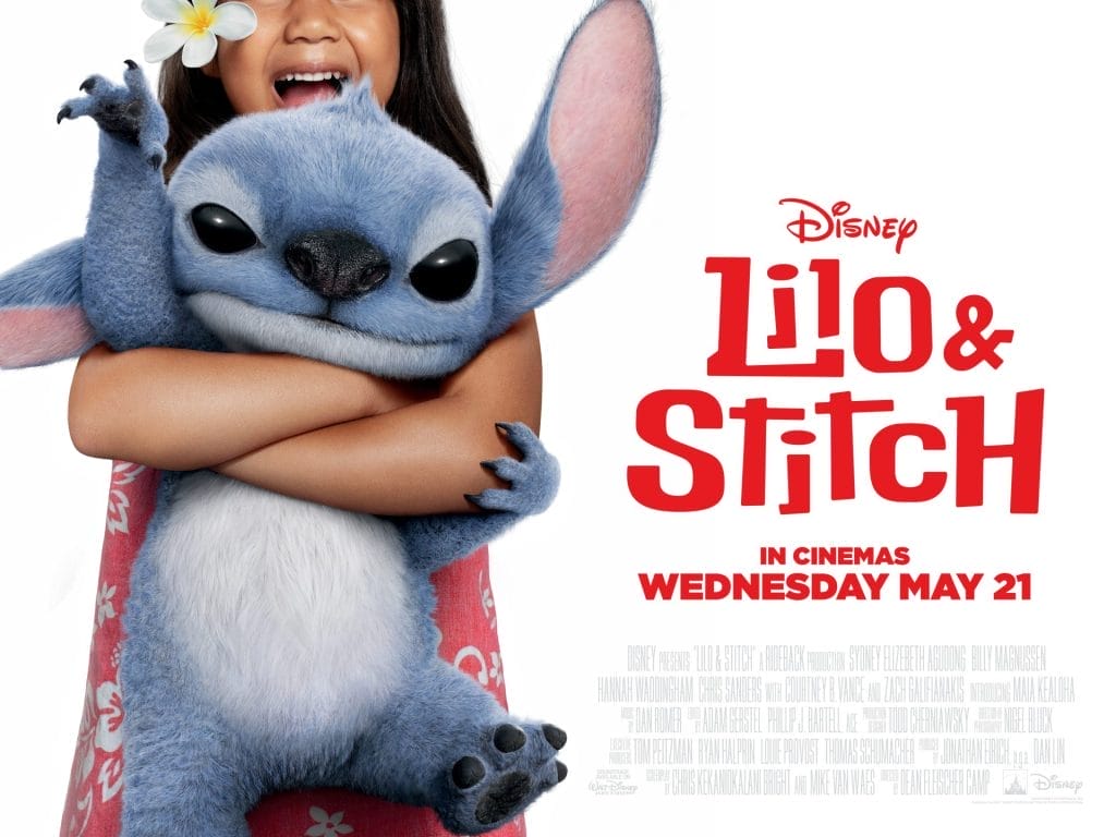 the beloved blue alien character Stitch being hugged by a young girl (Lilo) who has a plumeria flower in her hair. The poster indicates the film was released in cinemas on Wednesday, May 21st.