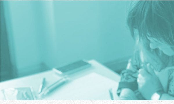 An Image with a blue overlay of a girl writing. There is a pink circle logo that says Tees Valley Creates