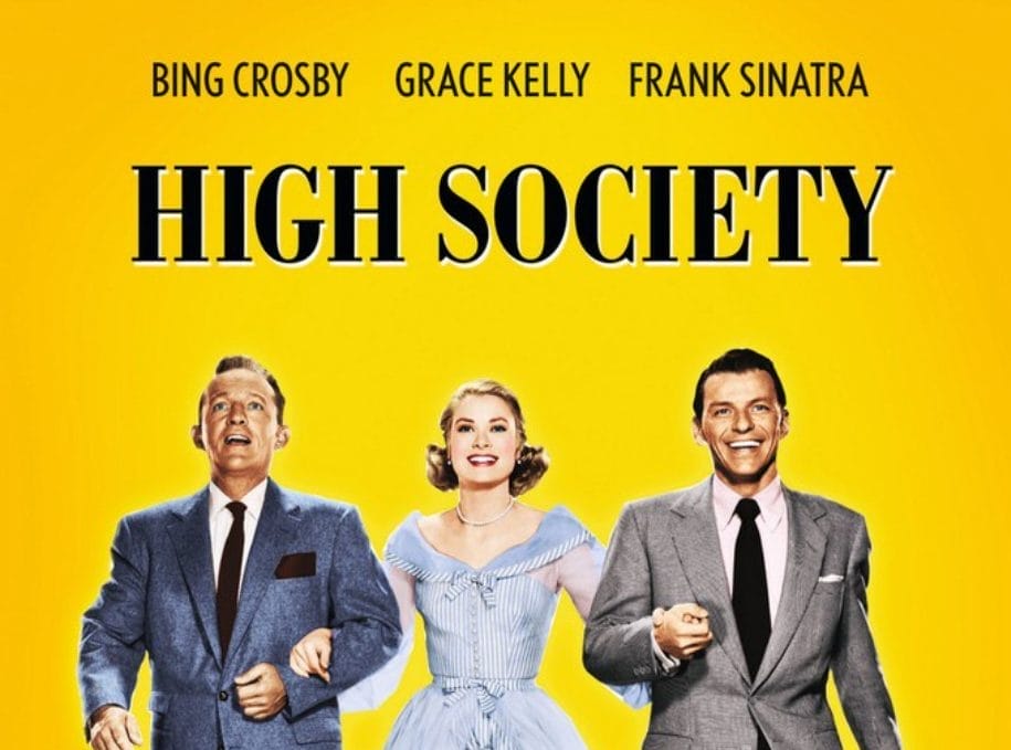 A Yellow background with Black text High Society. Actors Bing Crosby and Frank Sinatra both dressed in suits are linking arms with Grace Kelly dressed in a blue and white striped summer dress.