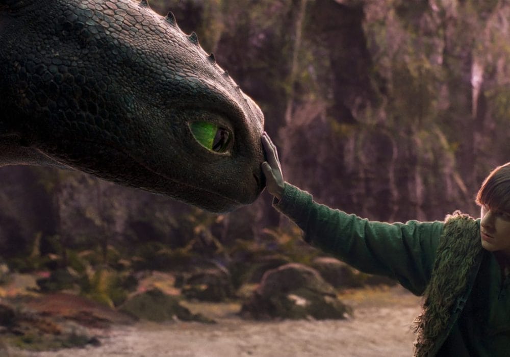 Image of a young boy stroking a dragon's nose.