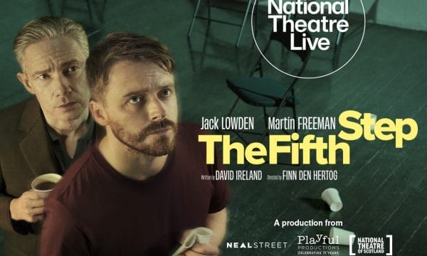 Two men in the foreground against a dark green background with wire mesh fencing. The man in front wears a dark red/burgundy top and holds a white cup, looking directly at the camera with a beard and serious expression. Behind him, an older man with grey hair in dark clothing looks over his shoulder. The National Theatre Live logo appears in a white circle in the upper right. Large yellow text reads "The Fifth Step" with "Jack LOWDEN Martin FREEMAN" above it. Smaller text shows "written by DAVID IRELAND Directed by FINN DEN HERTOG" and production credits for "NEAL STREET", "Playful PRODUCTIONS", and "NATIONAL THEATRE OF SCOTLAND" at the bottom.