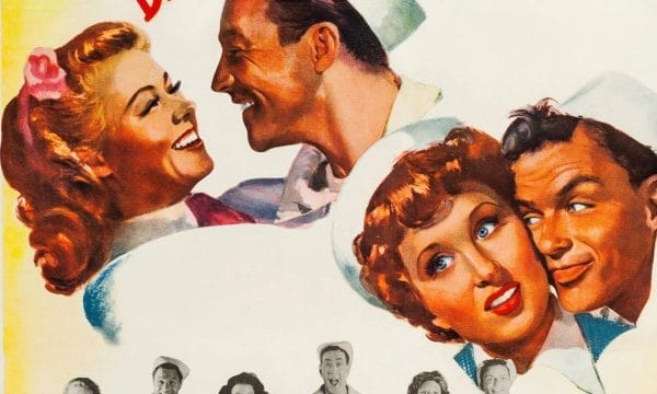 painted portraits of couples in 1940s or 1950s style. The main focus is on two romantic couples rendered in warm, golden tones typical of mid-century illustration. In the upper left, a blonde woman with a pink flower in her hair gazes lovingly at a dark-haired man in what appears to be a sailor's white uniform. In the lower right, another couple is shown - a woman with auburn hair and blue eyes looking at a man, also in naval attire.