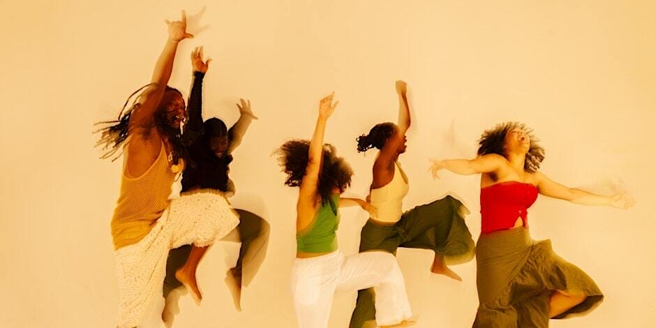 Five people dancing energetically against a plain background, dressed in vibrant and earthy-toned clothing, with expressive body movements and joyful expressions.