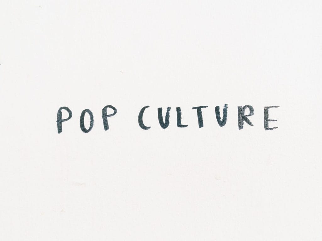 the words Pop Culture hand wrote on a white wall